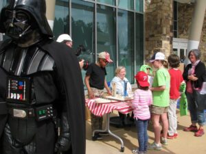 Darth Vader looks on as Drew Students explain to DESIGNORAMA attendees about the engineering behind their Soap Box Derby Race Car. Photo: Courtney Bryant