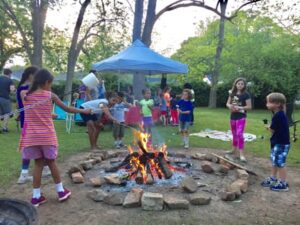 Kids cook s'mores around the campfire. Photo by Lewis Cartee.