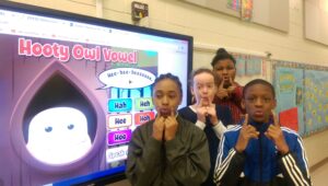 Burgess-Peterson chorus students practice their vowels with Quaver's Marvelous World of Music. (From left to right: Treasure Capers, Emilia Cartee, LaShele Watson, Cam'ron Barber). Photo by Ashleigh Spatz