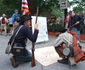 Living History soldiers review battle maps after the wreath laying ceremonies at the McPherson Monument in East Atlanta during the BATL commemoration of the historic Battle of Atlanta. This year the wreath layings will be on July 20th at both battlefield monuments. BATL is raising money to restore both of them. Photo: Ken Boff