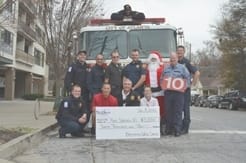 Firemen of Firehouse #10 accept check Photo by Emily Gober