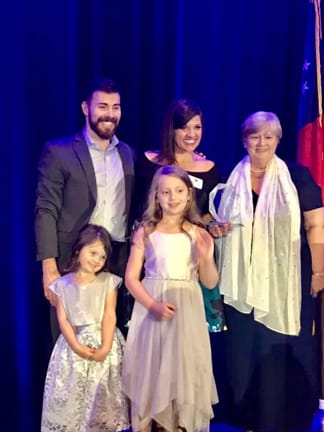 Tracey Pendley and family as she receives the GA Teacher of the Year Award accompanied by Dr. Bobbi Ford.