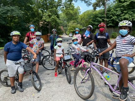 Photo courtesy of East Atlanta Kids Club Masked kids cycling at the EAKC