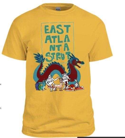 Yellow t shirt with text of East Atlanta Strut September 23 2023, and an illustration of a red dragon behind some musicians